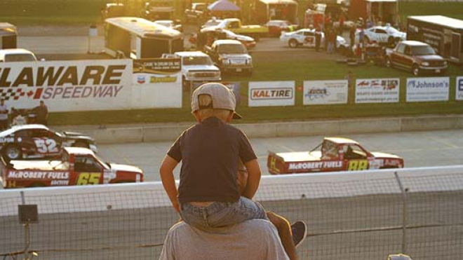 Father and son watching race cars 