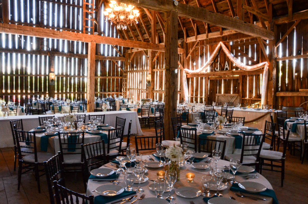 Venue set up with tables and chairs and string lights 