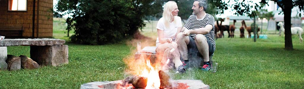 couple in front of a campfire 