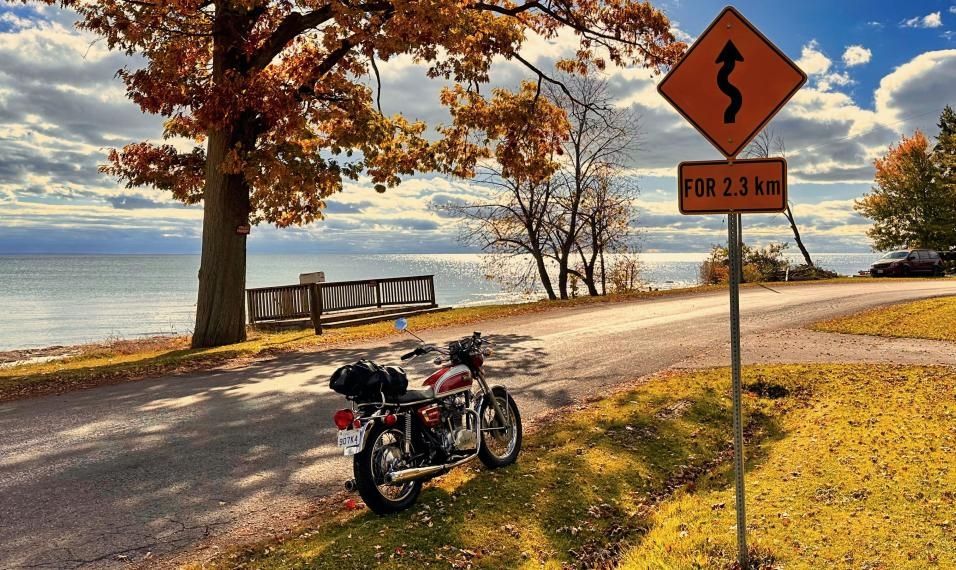 Two motorcycles by a lake