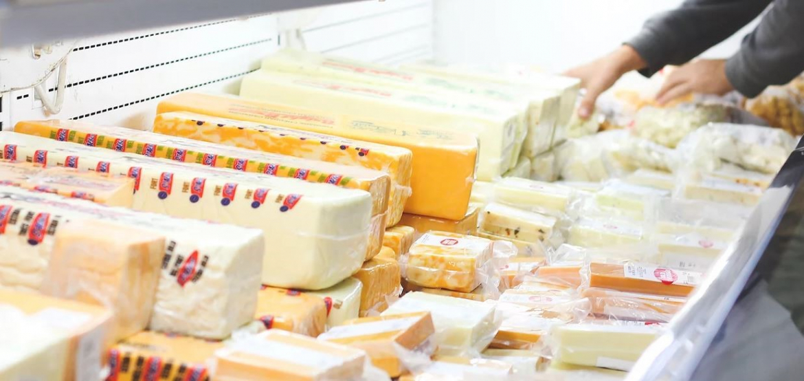 Variety of cheeses in a fridge 