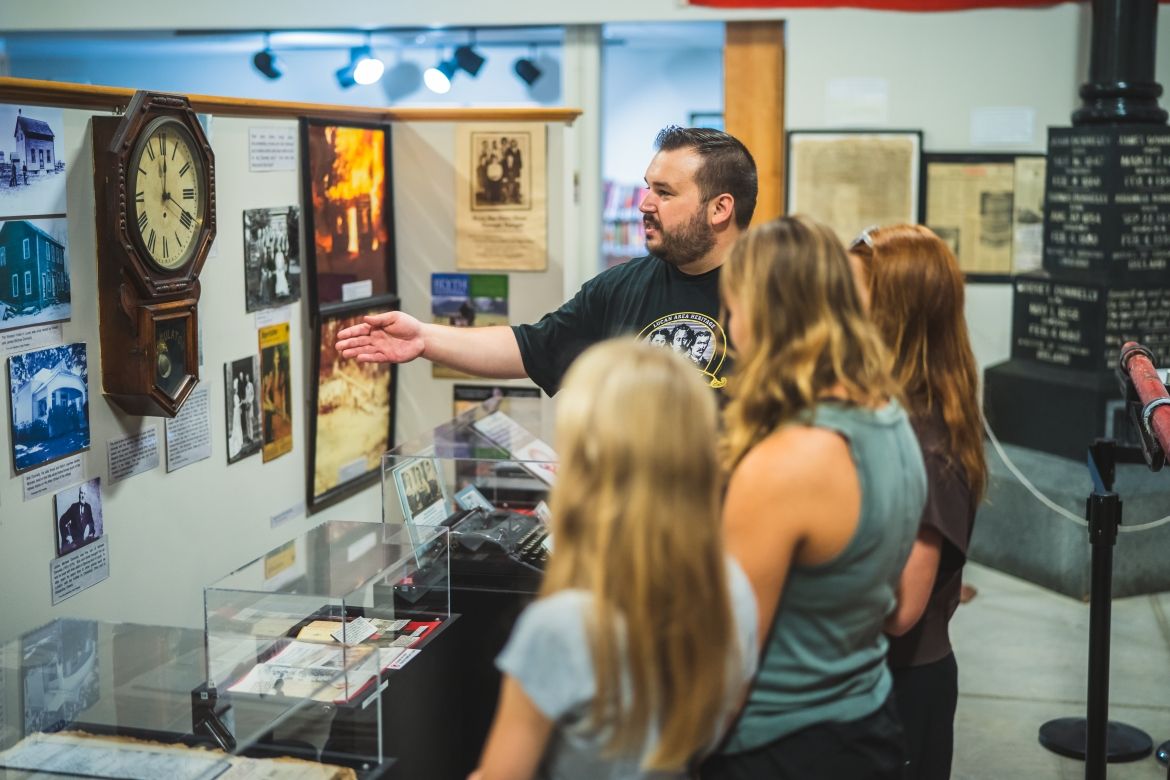 curator showing visitors artifacts