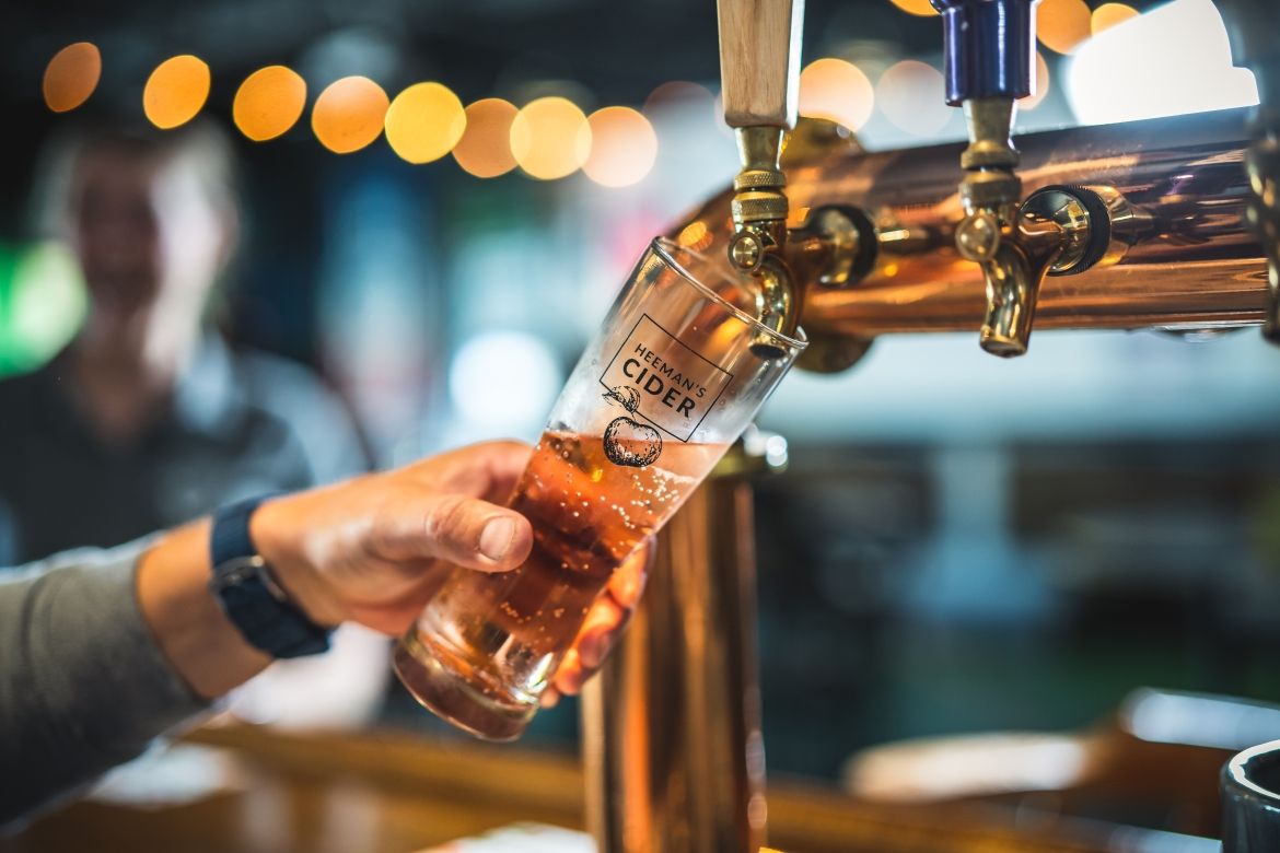 Tap pouring cider into a glass