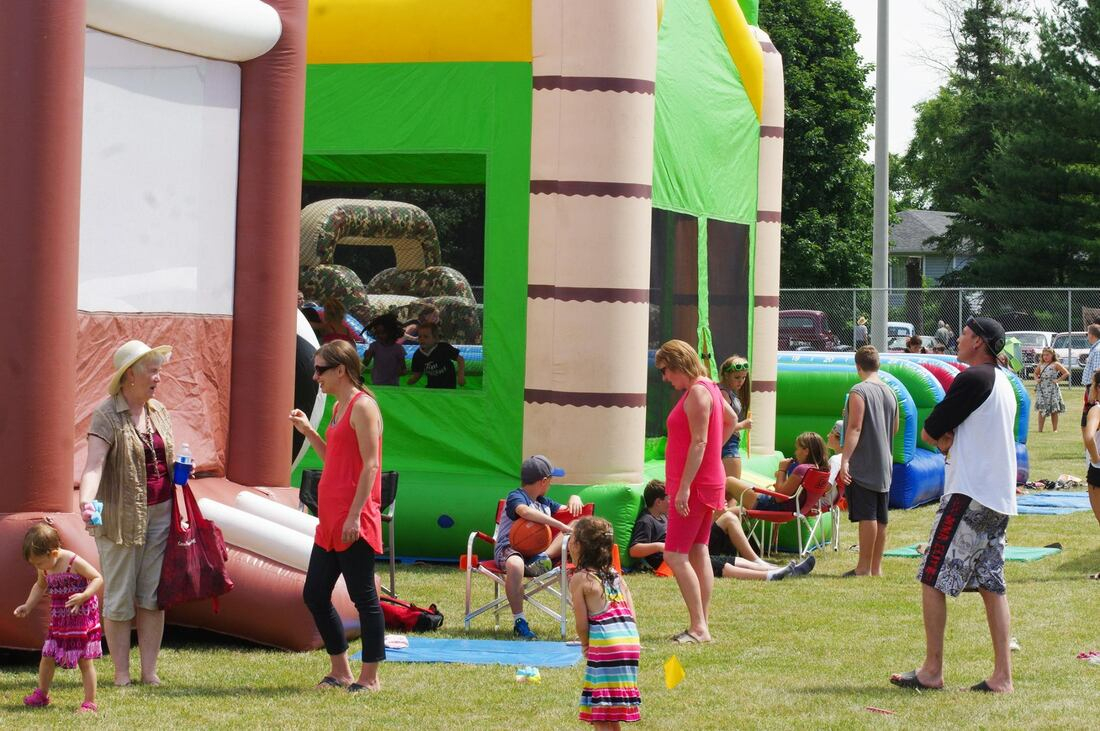 people in front of bouncy castles
