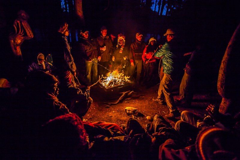 people gathered at campfire